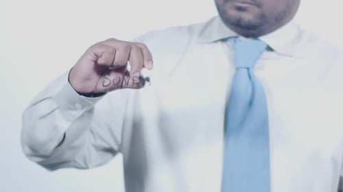 Person Writing "Sunday" With Marker on Clear Surface