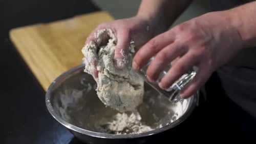 A cook preparing dough