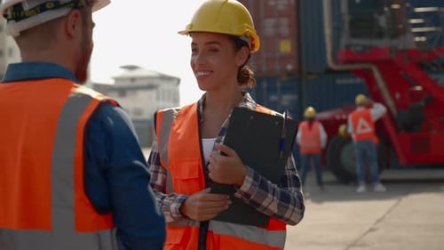Female Supervisor Giving High Five in Shipping Yard