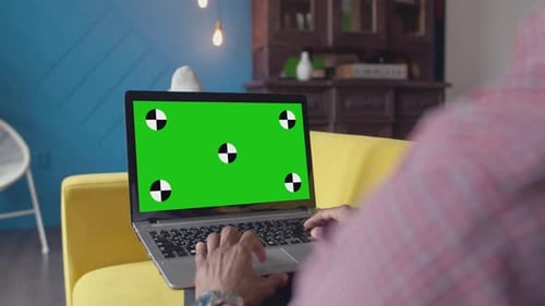 Typing on Laptop with Green Screen at Home