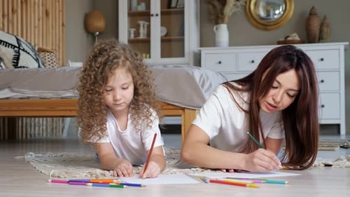 Girl and Woman Drawing Together Indoors
