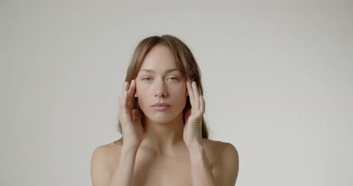 Woman Applies Relaxing Facial Massage, Close Up