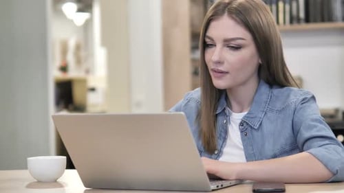 Woman Works at Laptop, Thinking at Her Desk