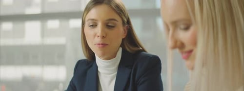 Businesswomen Discussing Project in Bright Office