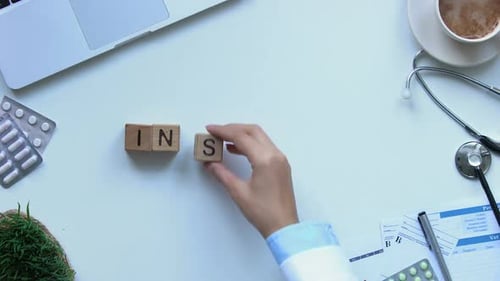 Insurance Word on Wooden Cubes Made by Doctors Hand, Health and Life, Top View