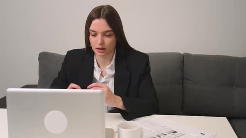 Woman Uses Laptop for Remote Business Meeting