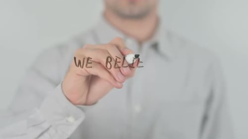 Man Writes, We Believe, On Glass