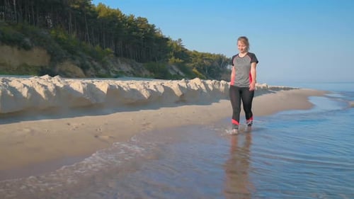 Barefoot Woman Walking on Beach