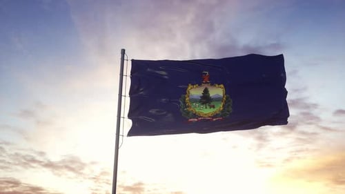 Waving Vermont State Flag Against a Vibrant Sunset Sky