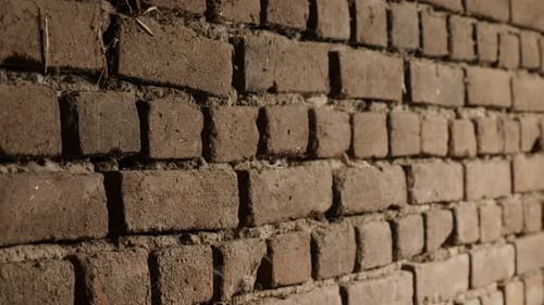 Bricks headers and stretchers close-up slow-tilt 4K 2160p 30fps UltraHD footage - Weathered house w