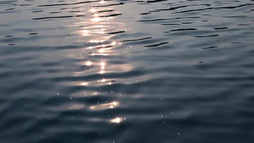 Sunlight Reflections on Rippling Lake Water