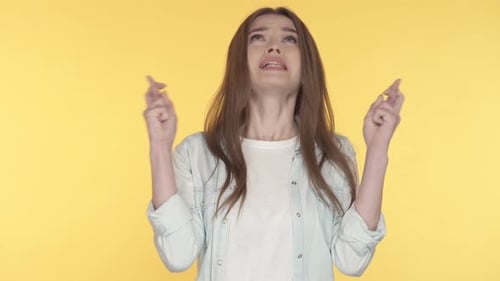 Worried Woman Crossing Fingers for Good Luck