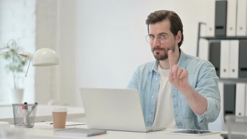 Man Typing on Laptop Computer at Desk