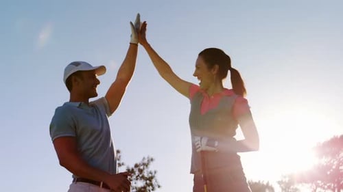Golfing Couple High Five on Sunny Course