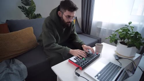 Man Playing Piano Keyboard in Apartment
