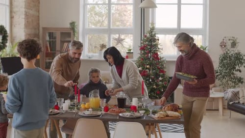 Family Lights Candles at Home for Christmas Meal
