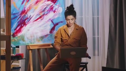 Artist Working on Laptop in Studio