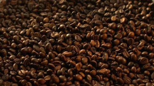 Roasted Coffee Beans Falling in a Pile