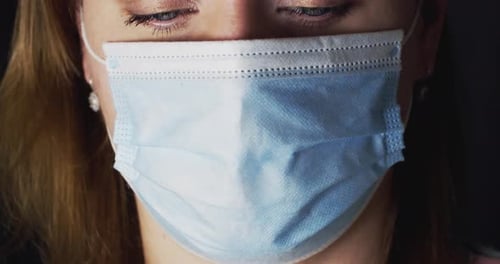 Woman Wearing Blue Face Mask Close Up