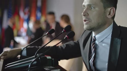 Man Giving Speech at Podium at a Conference