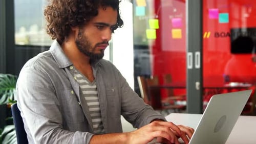 Business executive working on laptop at desk