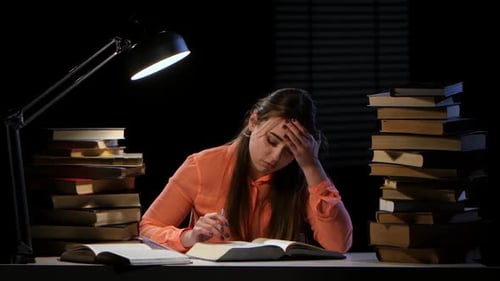 Girl Thumbs Through the Book and It Hurts Headaches. Black Background