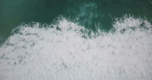 Drone Flying Right Above Giant Wild Rushing Sea Wave Crashing Down. Incredible Green Seafoam