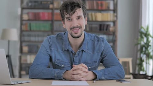 Portrait of Smiling Young Man Looking at Camera in Casual Office