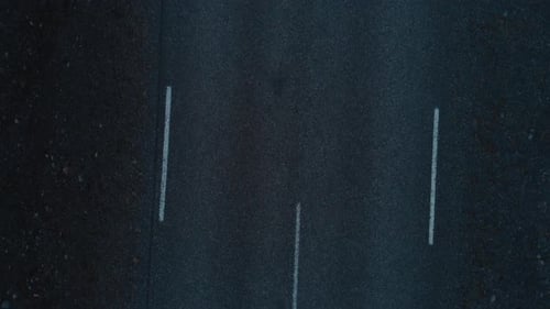 Man in red lying on empty road