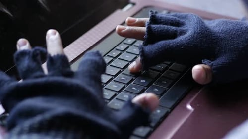 Hacker Hand Stealing Data From Laptop Top Down