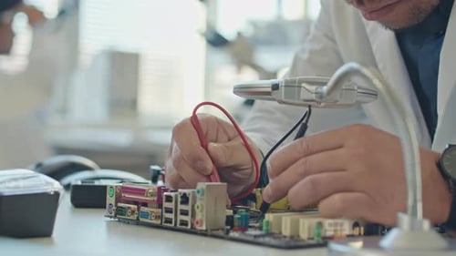 Engineer Working on Computer Motherboard in Laboratory