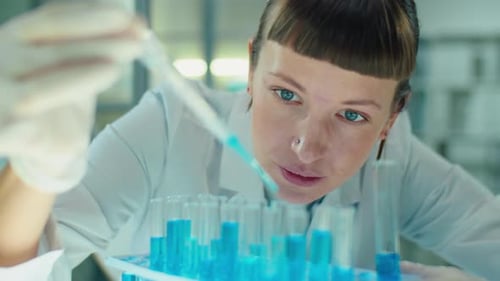 Woman Scientist Working with Test Tubes in Lab