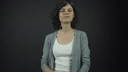 Thoughtful Woman Posing in Studio with Cardigan