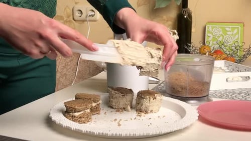 A Woman Makes A Biscuit Cake. Applies Butter Cream To The Workpieces.