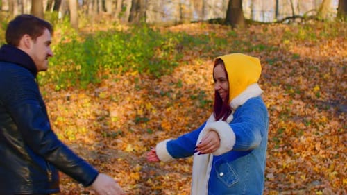 Happy Couple Embracing Outdoors in Autumn Forest