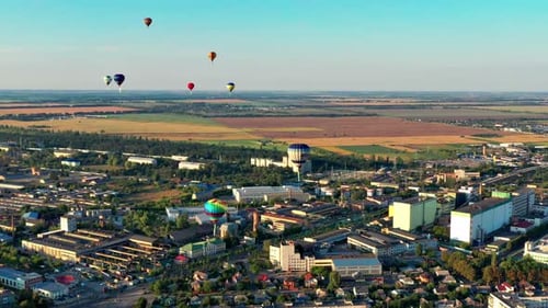 Cityscape with Hot Air Balloons and Rural Surroundings