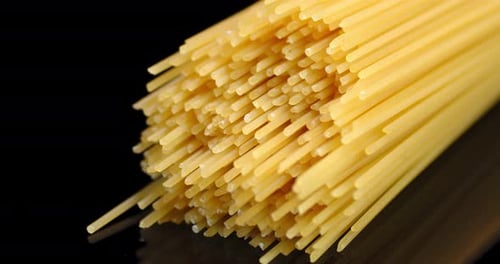 Close Up of Uncooked Spaghetti on Black Background