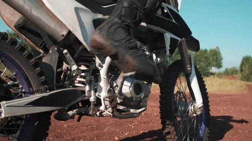 Close Up of Rider Kick-Starting Motorcycle