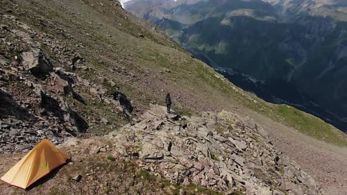 Woman Stands on Stone and Enjoys View of Elbrus Mountains