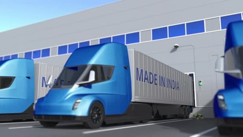 Modern Trailer Trucks with MADE IN INDIA Text at Warehouse