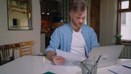 Business Man Freelancer Working on Laptop and Analyzing Paper Document Spbas