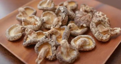 Dried Shiitake Mushrooms on a Wooden Plate