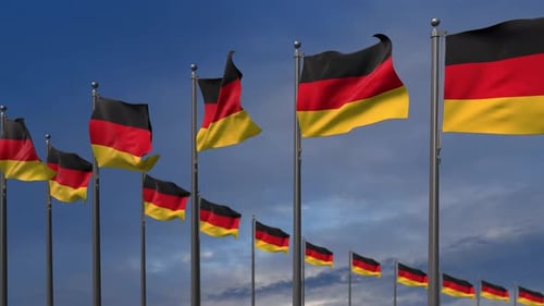 German National Flags Waving Against Blue Sky