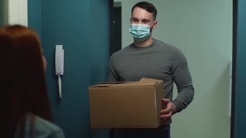 Delivery Man Giving Package to Woman at Door