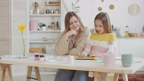 Mother and Child Drawing Together at Table