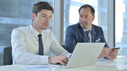 Businessmen Reviewing Project in Modern Office