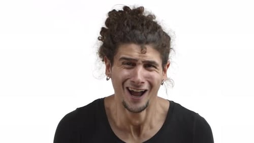 Closeup of Silly Emotional Young Man with Beard and Curly Hairstyle Starting to Cry and Losing