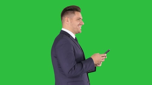 Mature businessman using mobile phone texting message on