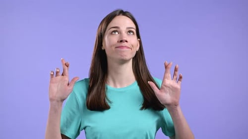 Woman Crossing Fingers Hoping for Good Luck