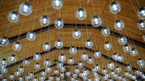 Luxury interior of glass light bulbs. Futuristic pendant lights of round shape. Many shiny balls on